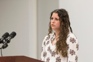 A woman speaks at a podium